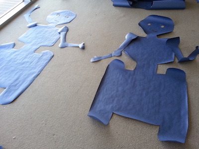 two blue paper robots on the floor