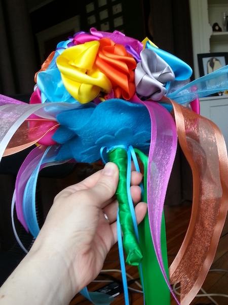 felt flowers and green ribbon on the underside of a satin ribbon flower bouquet