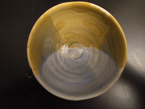 top down bowl with half matte yellow glaze and half shiny pale blue glaze
