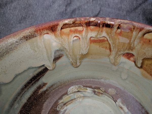 close up of dripping glaze on the rim of a bowl