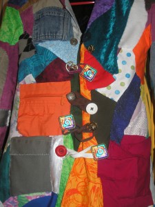 buttons and loops on the front of a patchwork coat