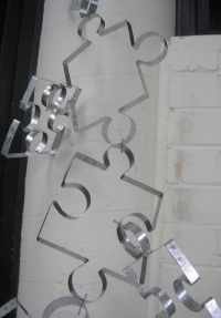 Close-up of steel puzzle piece frames connected end-to-end