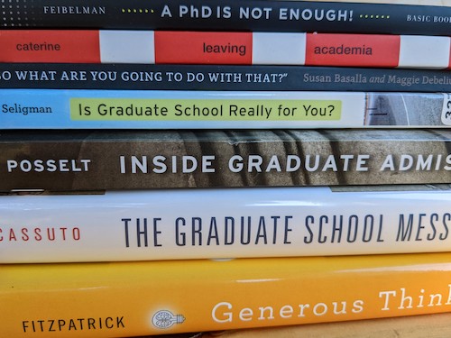 a stack of hardback books about graduate school