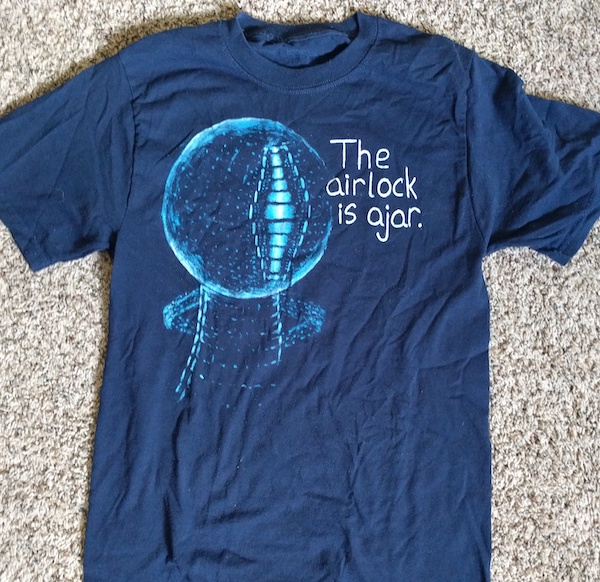 t-shirt with a picture of EDI from Mass Effect and the text 'the airlock is ajar'