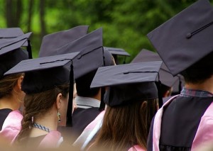 backs of students heads, wearing black motorboard hats and tassels - photo by Terry Bolstad